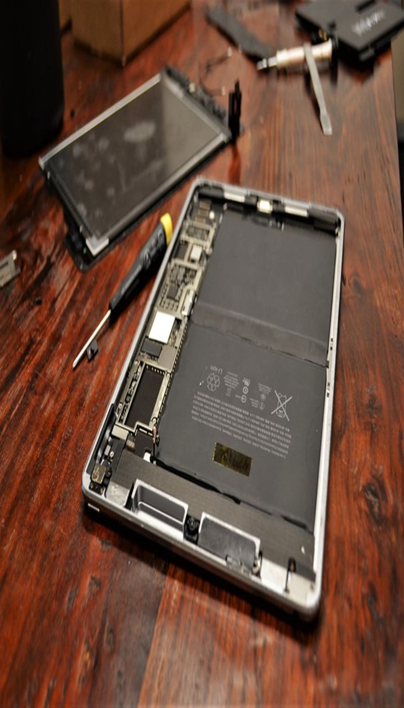 Technician performing iPad battery replacement in Ocala shop